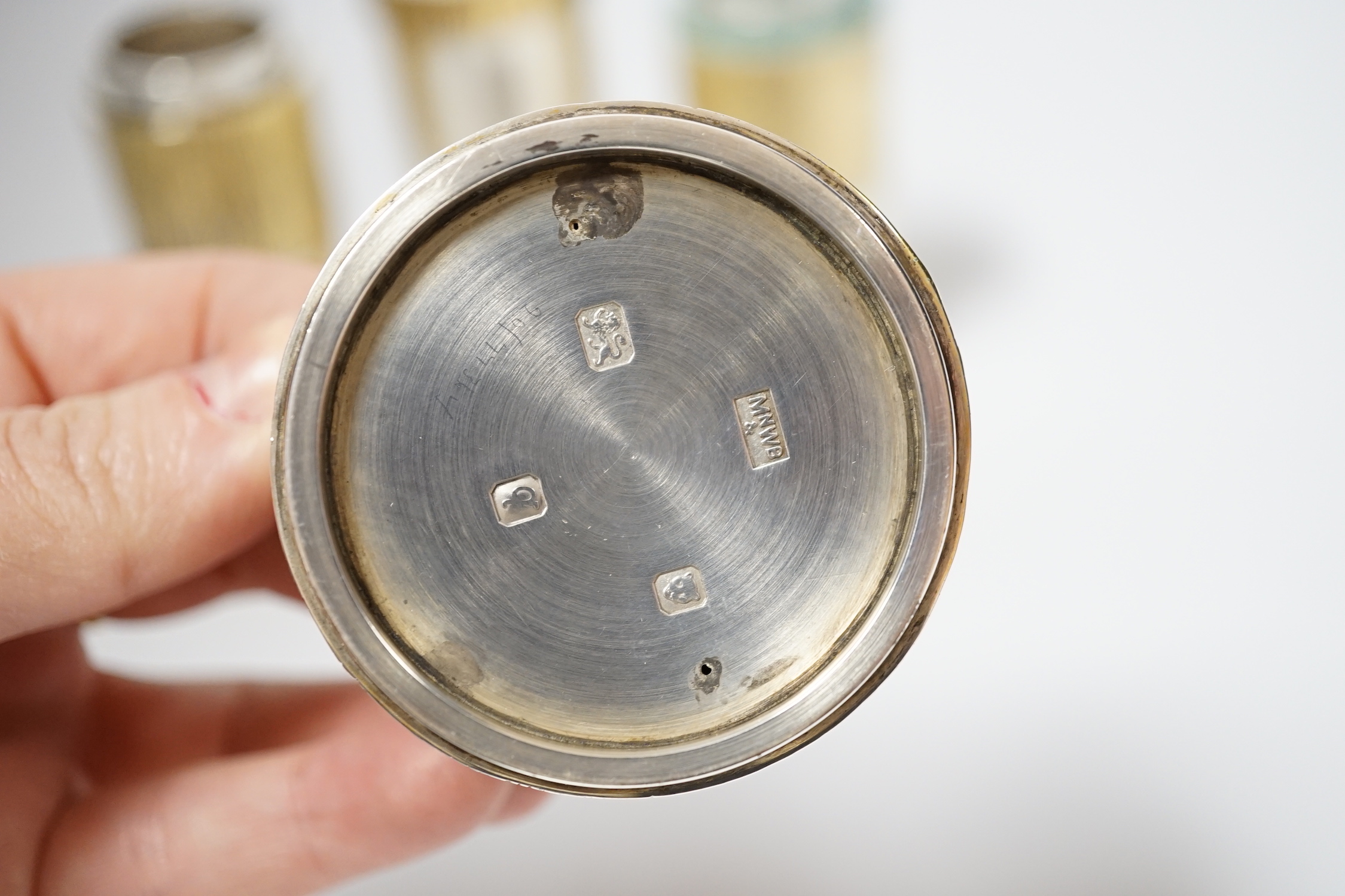 A suite of four Elizabeth II parcel gilt silver condiments, comprising a cylindrical salt, pepper and pepper grinder and a tub salt, Mappin & Webb, London, 1971, tallest 10.5cm.